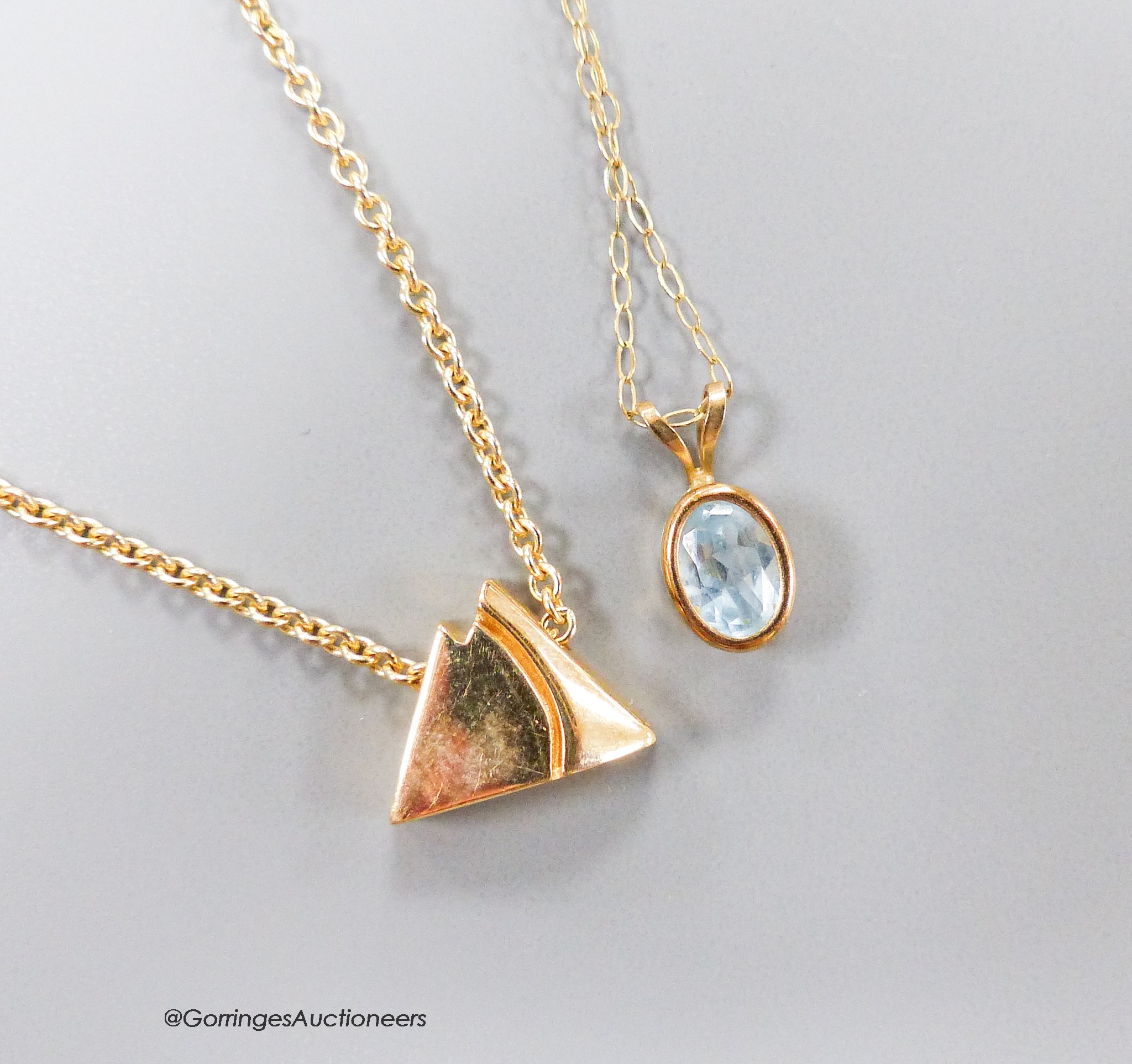 A 14ct gold triangular pendant on 14ct gold chain, gross 5.7 grams, an aquamarine pendant on 9ct fine gold chain and another 9ct gold chain, gross 3.4 grams.